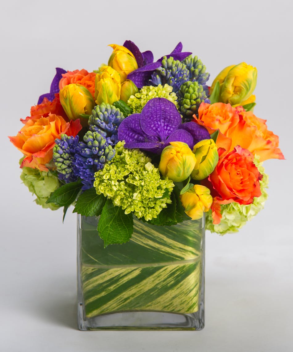 Deep oranges, blues, purples, and greens come together in our signature leaf-lined cube vase