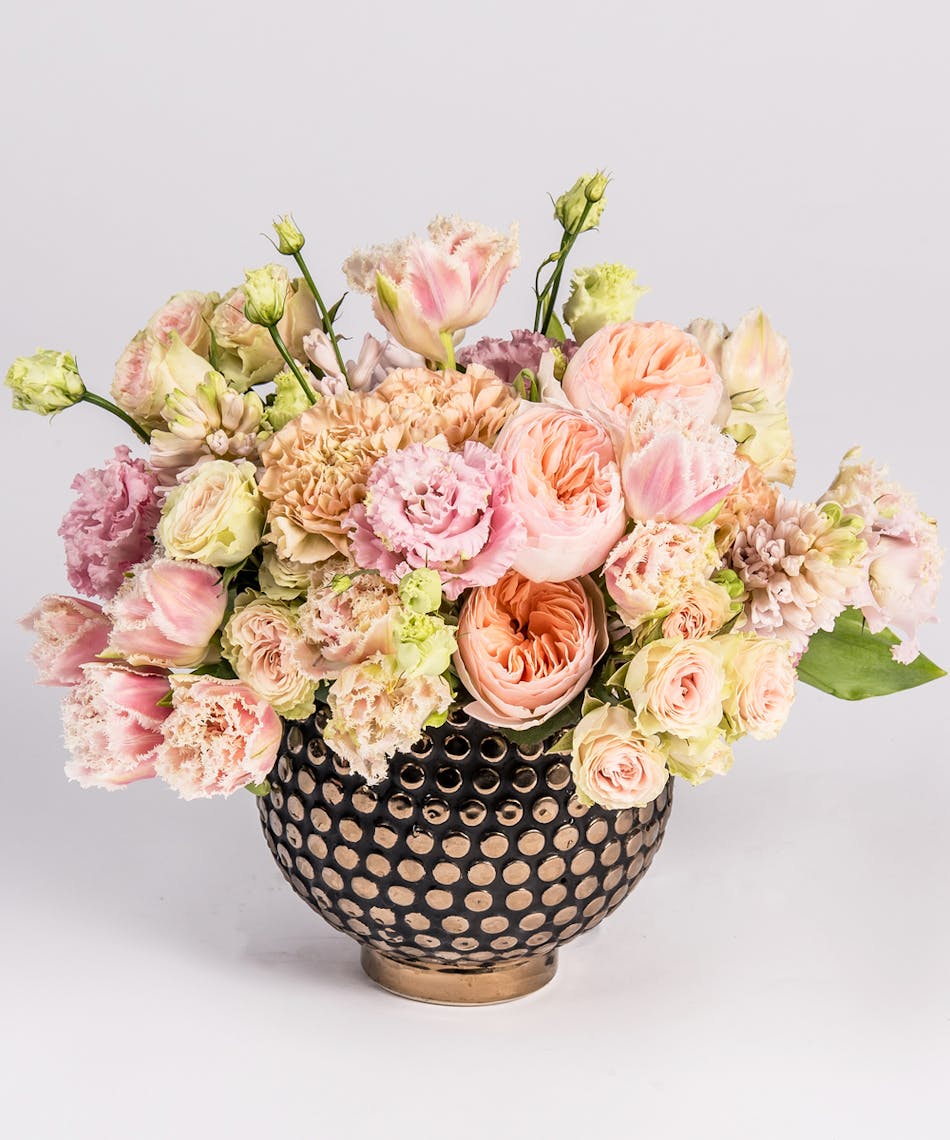 peach garden roses and pink frilled tulips in a gold container