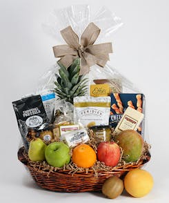 A wide variety of individually-packaged snacks in a round gift basket