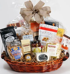 A wide variety of individually-packaged snacks in a round gift basket
