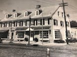 A black-and-white photograph of our building exterior, as seen in the 1970s